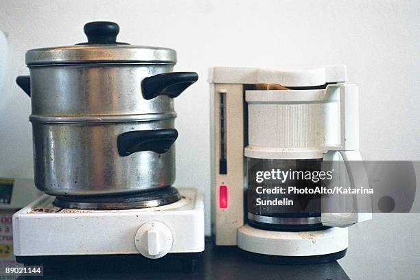 steamer on hotplate set next to coffee maker on counter - dirty pan stock pictures, royalty-free photos & images