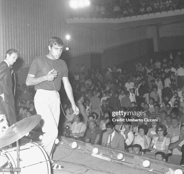 Adriano Celentano sings for the Rock and Roll Festival at the 'Maestoso theater' and Armando Zappi is with him on stage, Rome 1961. Adriano Celentano...