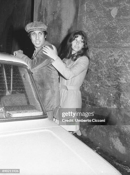 Adriano Celentano at the exit of a night club with a friend in Rome in 1972. He is a famous Italian singer, composer, producer, comedian, actor, film...