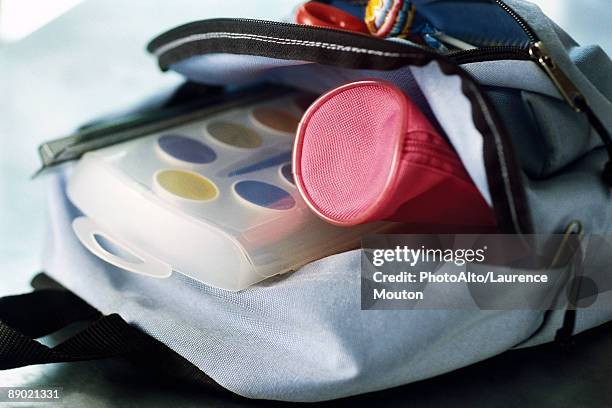 backpack containing pencil case and watercolor paints - etui stockfoto's en -beelden