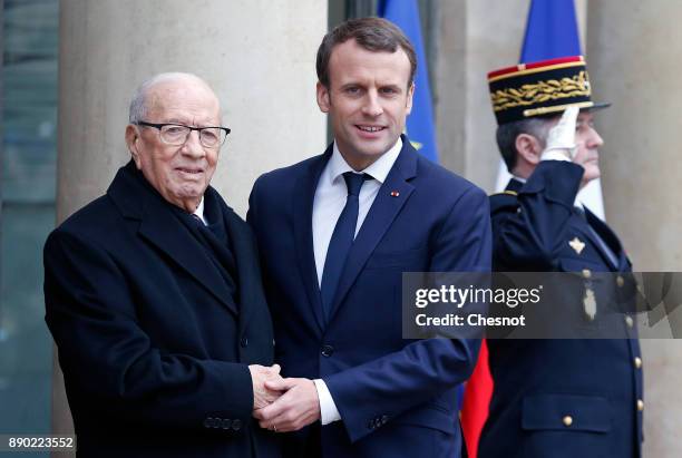 French President Emmanuel Macron welcomes Tunisian President Beji Caid Essebsi prior to their meeting at the Elysee Presidential Palace on December...