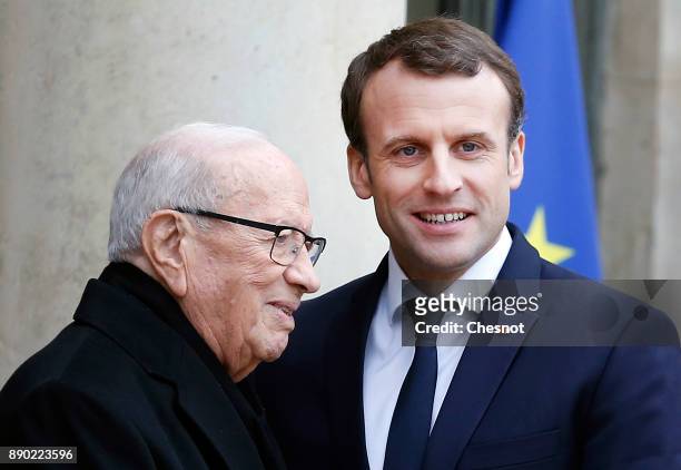 French President Emmanuel Macron welcomes Tunisian President Beji Caid Essebsi prior to their meeting at the Elysee Presidential Palace on December...