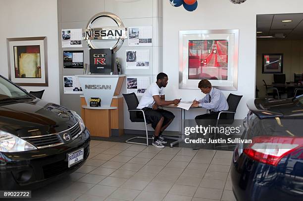 Customer at Serramonte Nissan fills out a credit application with a salesman July 14, 2009 in Colma, California. The Commerce Department reports that...