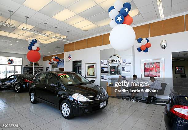 Customer at Serramonte Nissan fills out a credit application with a salesman July 14, 2009 in Colma, California. The Commerce Department reports that...