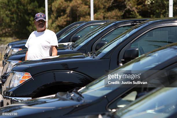 Customer browses new cars displayed on the sales lot at Serramonte Nissan July 14, 2009 in Colma, California. The Commerce Department reports that...