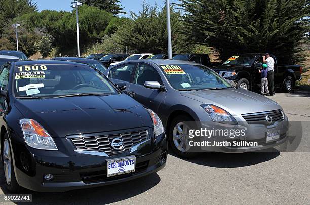 Customers browse new cars displayed on the sales lot at Serramonte Nissan July 14, 2009 in Colma, California. The Commerce Department reports that...