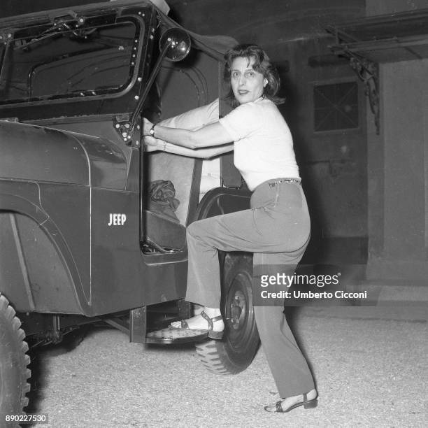 Italian stage and film actress Anna Magnani gets on the jeep at 'Palazzo Altieri', Rome 1957.