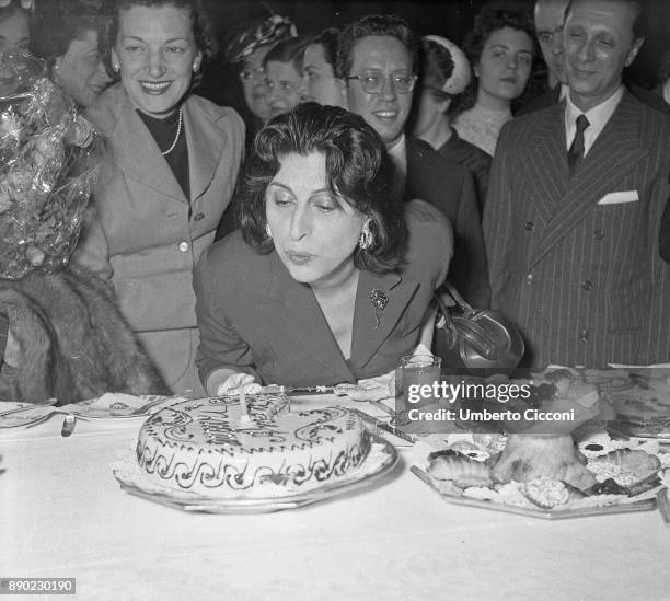 Italian stage and film actress Anna Magnani celebrates at the 'Excelsior Hotel' for having received the 'Viola D'oro', Rome 1956.