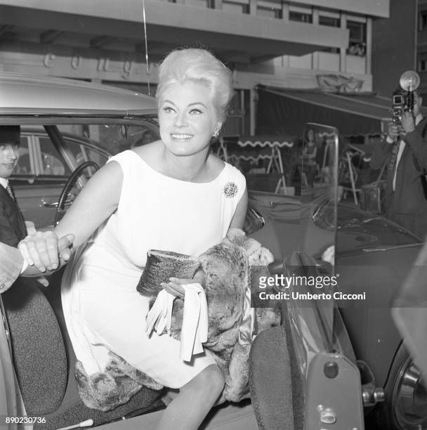 Swedish actress Anita Ekberg gets out of the car to go to a cocktail party for the movie 'Boccaccio '70', Rome 1961. The event is held in the area...