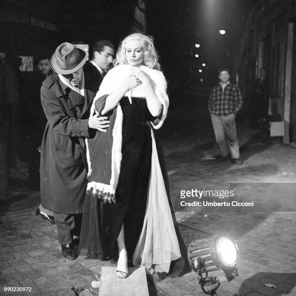 Italian film director Federico Fellini directing actress Anita Ekberg during the shooting of movie 'La Dolce Vita', Rome 1959.