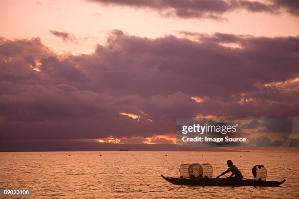 fisherman at sunrise - negros oriental stock-fotos und bilder