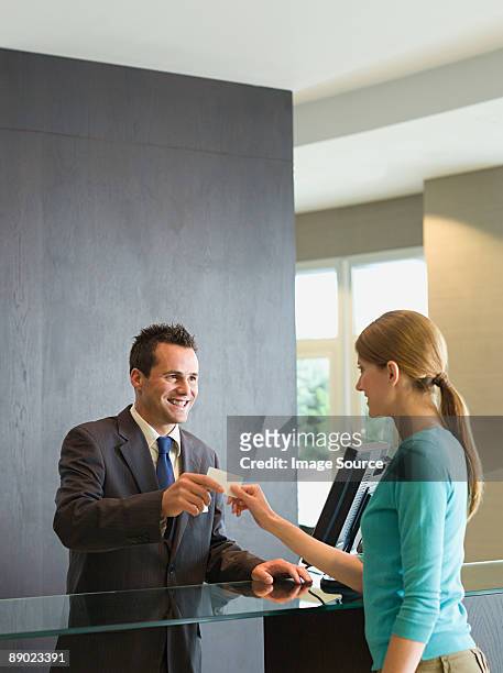 woman checking into a hotel - hotel key stock pictures, royalty-free photos & images
