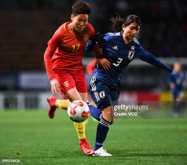 Aya Sameshima of Japan and Li Ying of China compete for the ball during the EAFF E-1 Women's Football Championship between Japan and China at Fukuda...