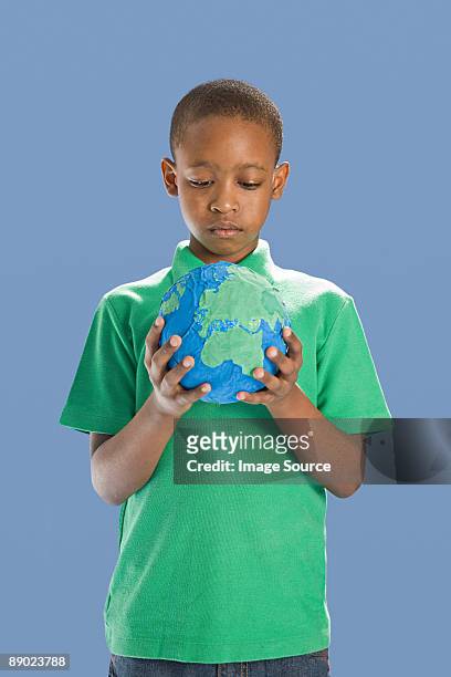 boy with globe - papier stock pictures, royalty-free photos & images