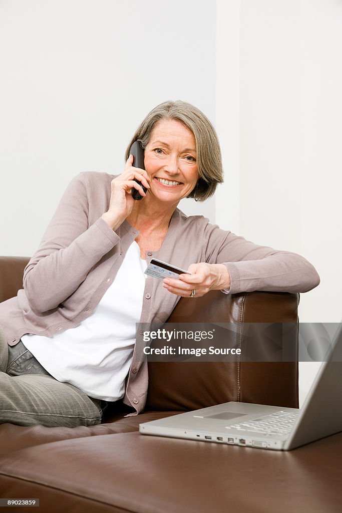 Mature woman using telephone banking