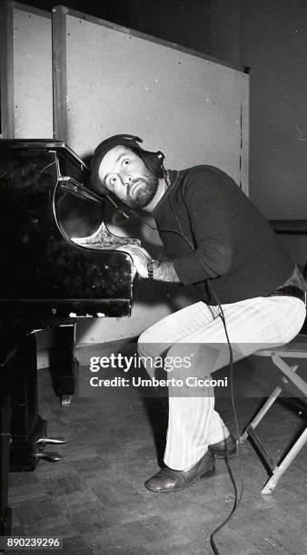 Italian singer-songwriter Lucio Dalla plays the piano and records a song in his studio, Rome 1971 .