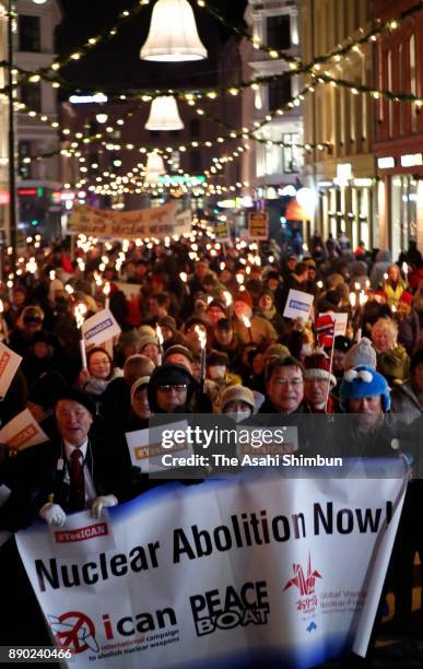 Members and people march on calling for abolition of nuclear weapons after the Nobel Peace Prize ceremony at the Oslo City Hall on December 10, 2017...