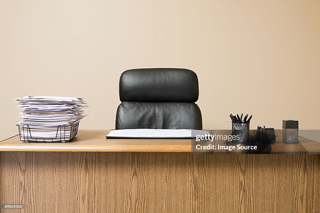 Office desk with overflowing inbox