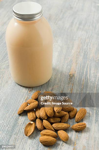 almonds and body lotion - bubble bath bottle stock pictures, royalty-free photos & images