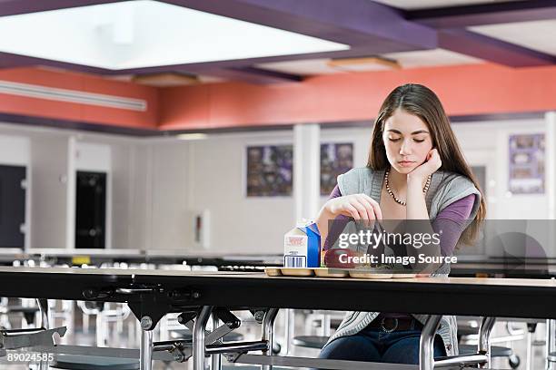 girl alone at lunch - american girl alone stock-fotos und bilder