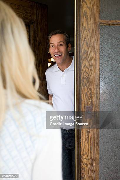 man opening door - answering stock pictures, royalty-free photos & images