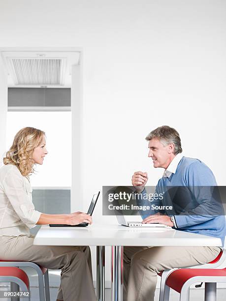 couple using laptop computers - profile laptop sitting stock pictures, royalty-free photos & images