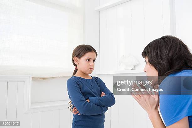 mother disciplining her daughter - aggressione foto e immagini stock