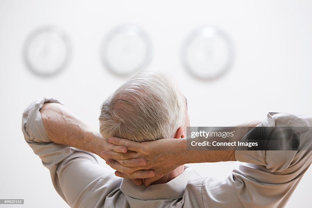 Man with hands behind head