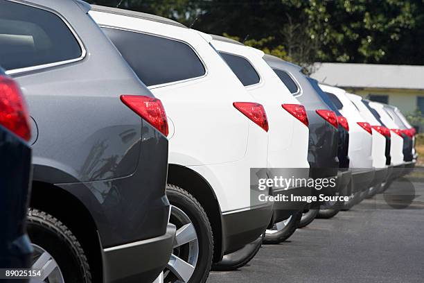 new cars in parking lot - cars in a row stock pictures, royalty-free photos & images