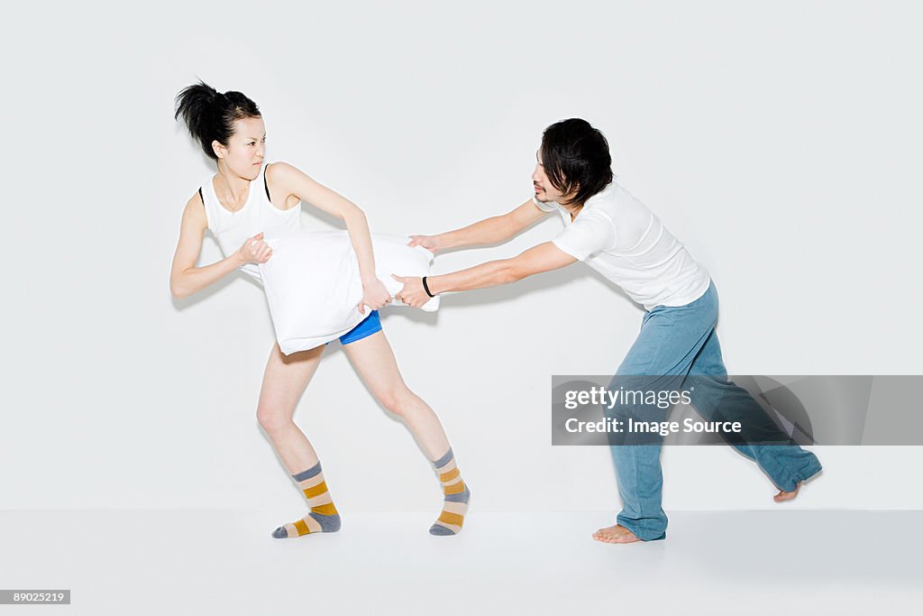 Couple fighting over pillow