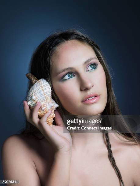 Sea Shell In Ear Shape Seashell Ear Photos and Premium High Res Pictures - Getty Images