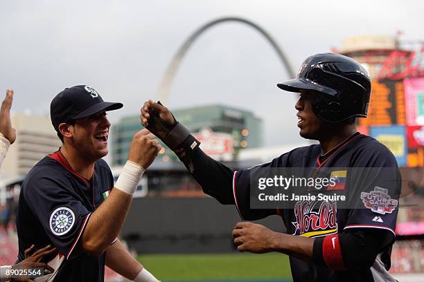 World Futures All-Star Alex Liddi of the Seattle Mariners congratulates Alcides Escobar of the Milwaukee Brewers for his home run during the 2009 XM...