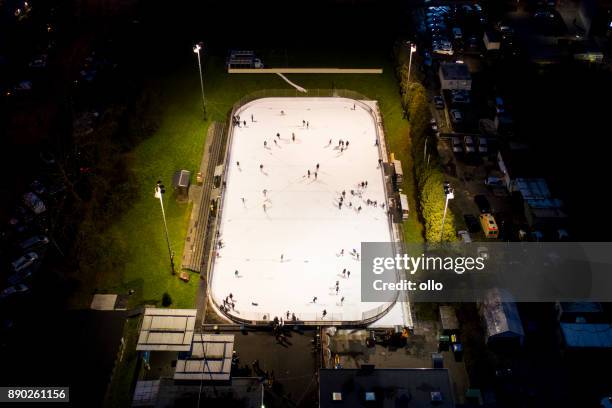 public ice rink at dusk - aerial view - ice rink overhead stock pictures, royalty-free photos & images