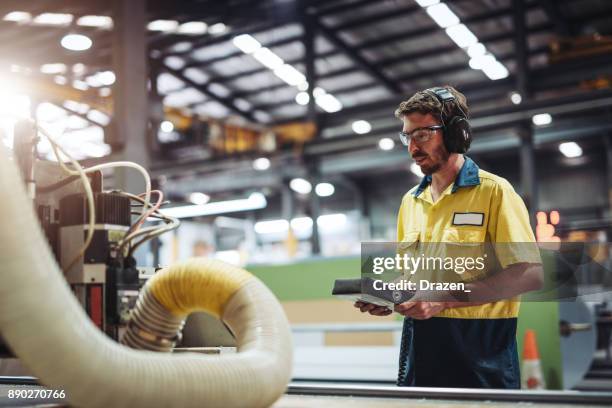 employee in australia working with automated machine - installing software stock pictures, royalty-free photos & images