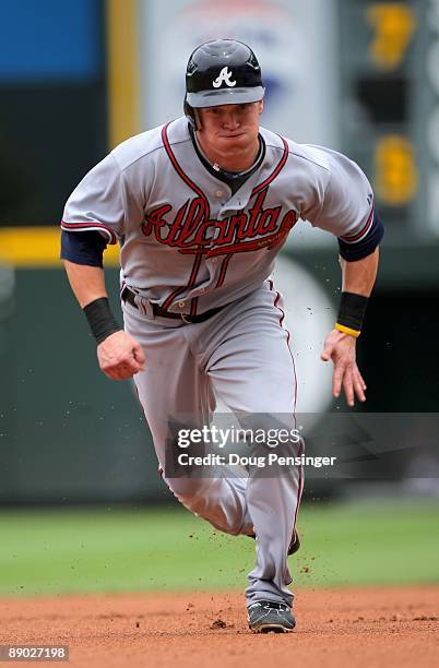 Nate McLouth of the Atlanta Braves runs the base path as he heads for thirdbase on a Martin Prado single in the first inning against the Colorado...