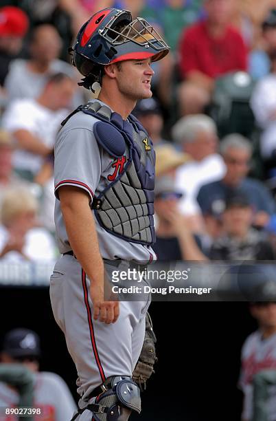 Catcher David Ross of the Atlanta Braves looks on during a pause in the action as he plays defense against the Colorado Rockies during MLB action at...