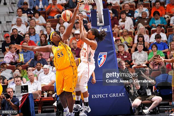 Tan White of the Connecticut Sun passes against Vanessa Hayden of the Los Angeles Sparks during a WNBA game on July 14, 2009 at the Mohegan Sun Arena...