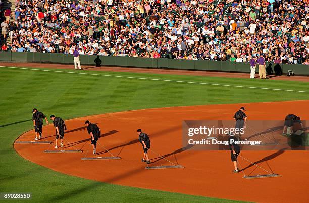 The grounds crew drags the infield between innings as the Colorado Rockies face the Atlanta Braves during MLB action at Coors Field on July 09, 2009...