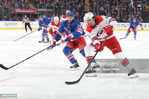 Justin Williams of the Carolina Hurricanes skates with the puck against Paul Carey of the New York Rangers at Madison Square Garden on December 1,...