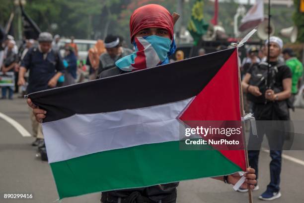 Indonesian muslim hold a Palestina flag flags during a protest in front of U.S Embassy in Jakarta, Indonesia, on December 11, 2017 against the U.S....