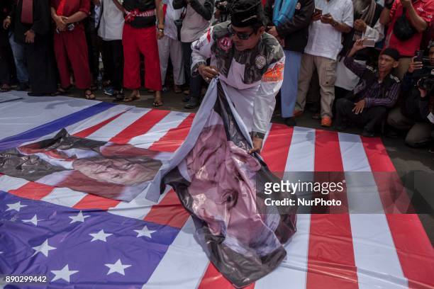 Indonesian muslim hold a placard of U.S President Donald Trump's face and Prime Minister of Israel Benyamin Netanyahu face during a protest in front...