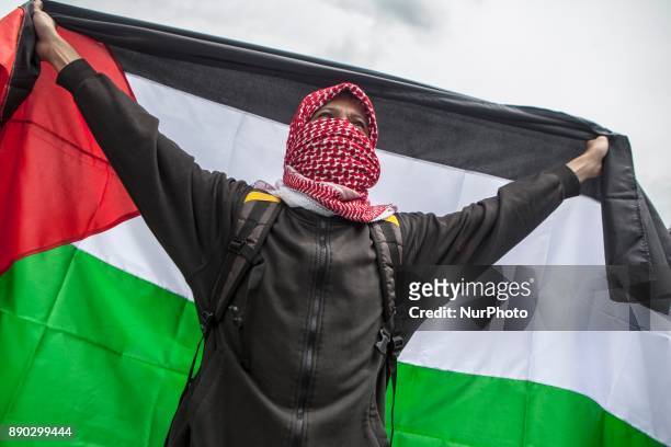 Indonesian muslim hold a Palestina flag flags during a protest in front of U.S Embassy in Jakarta, Indonesia, on December 11, 2017 against the U.S....