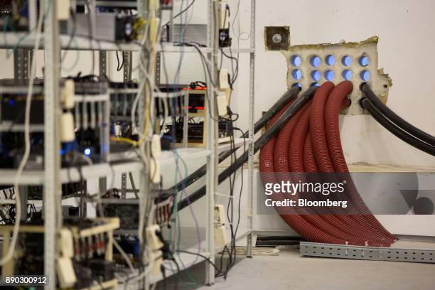Protective armor covers cable bundles used in the operation of cryptocurrency mining machines at the SberBit mining 'hotel' in Moscow, Russia, on...