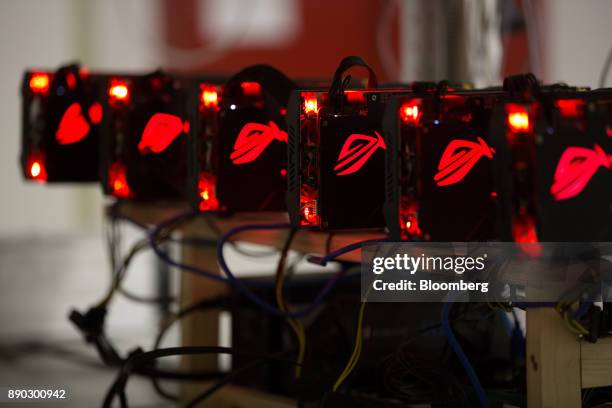 Red lights illuminate cryptocurrency mining rig units at the SberBit mining 'hotel' in Moscow, Russia, on Saturday, Dec. 9, 2017. Futures on the...