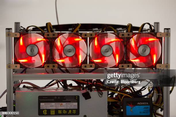 Red light illuminates cooling fans used to cool cryptocurrency mining rigs at the SberBit mining 'hotel' in Moscow, Russia, on Saturday, Dec. 9,...