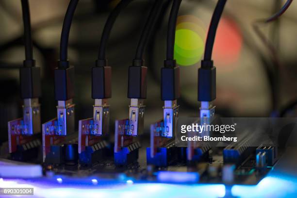 Blue data connector cables sit on a circuit board used in cryptocurrency mining machines at the SberBit mining 'hotel' in Moscow, Russia, on...