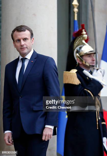 French President Emmanuel Macron looks on as Tunisian President Beji Caid Essebsi leaves the Elysee Presidential Palace after their meeting on...
