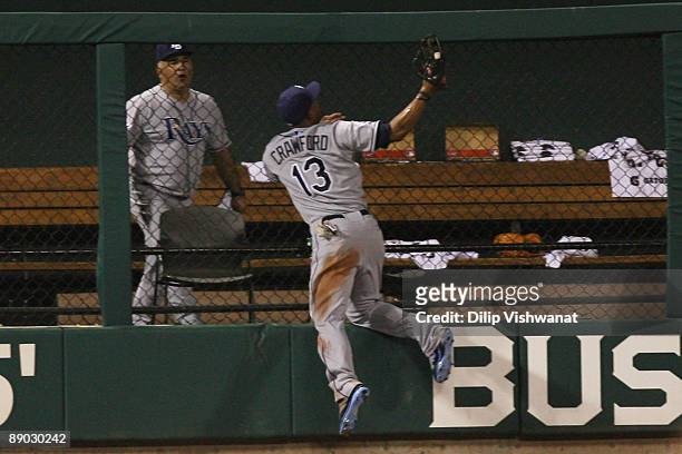 American League All-Star Carl Crawford of the Tampa Bay Rays robs a home run from National League All-Star Brad Hawpe of the Colorado Rockies during...