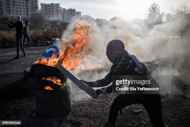 Palestinian youth light tires on fire as they clash with Israeli Defence Forces in the streets on December 11, 2017 in North of Ramallah, West-Bank....