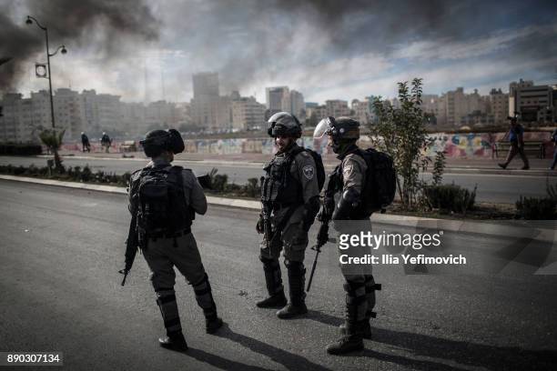 Israeli Defence Forces look on as they clash with Palestinian youth in the streets on December 11, 2017 in North of Ramallah, West-Bank. Protest...